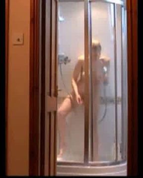 Busty blonde MILF masturbates to a loud shaking orgasm with her showerhead