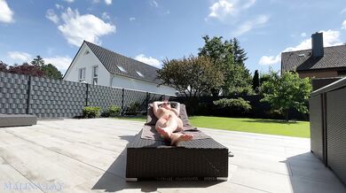 Hot MILF pampers her sexy body on the terrace and oils herself up