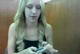 Hussy blonde shows off her cleavage in front of a web cam