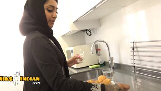 Attractive Muslim woman wearing hijab while giving a BJ