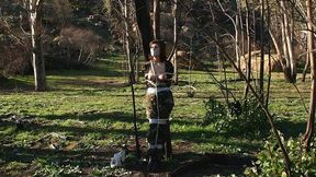 Lead Outdoors And Tied To A Tree, Corporal Marlena Mercurio Awaits The Rescue Team!