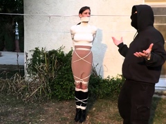 Sexy housewife tied up and gagged in BDSM training outside