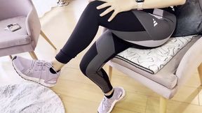 A Woman Warms up After the Gym by Touching Her Sweaty Feet