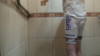 Masturbating under shower in white bicycle clothing
