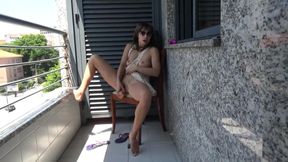 Brunette is hot masturbating on the balcony.