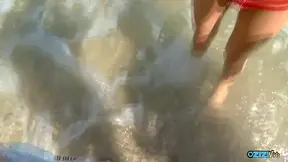 Being aroused while on the beach leads to the brunette joyfully riding on his manhood