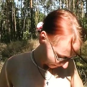 Amazing redhead with small tits masturbates her wet pussy with a dildo outdoors