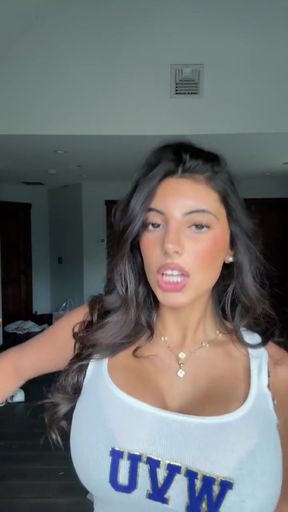 Woman in white tank top with blue lettering