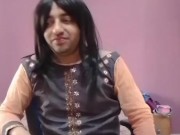 Young sissy crossdresser femboy in a cute little dress on the chair.