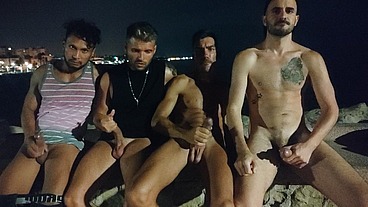 Friends having fun playing with their dicks at night close to the beach