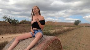 Blonde Fingers Herself on the Straw Field