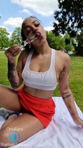 British mixed girl plays with her pussy in public park