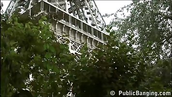 Slutty brunette is sucking dick and having a threesome, under the Eiffel Tower, during the day