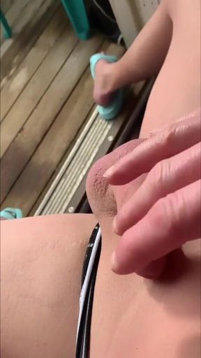 Smooth sexy femboy, under the sun on the balcony, plays with a soft cock straight outside
