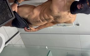 Cyclist with a huge penis showing its bulge in his shorts and urinating heavily.