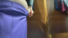 Curvy MILF in the mall fitting room trying on skirts.