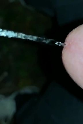 Slowmotion and Close up. Unwashed Uncut Cock Piss on the Ground Outdoor. Long Piss Stream