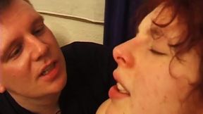 Mature redhead mom gets her huge natural knockers out as she submits to her masters.