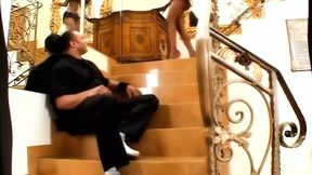 Dark-haired beauty enjoys intense pleasure on the staircase