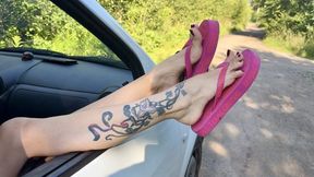 Pink flip flops on my pretty feet with long toes in outdoor, on the road, grass, in the car, red toenails polish