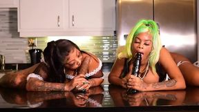 Two enormous booty maids take turns sucking on a big black dildo, giving each