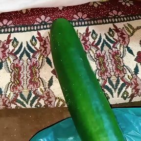 Aunty drains the water from the cucumber while relishing the cucumber to the fullest.