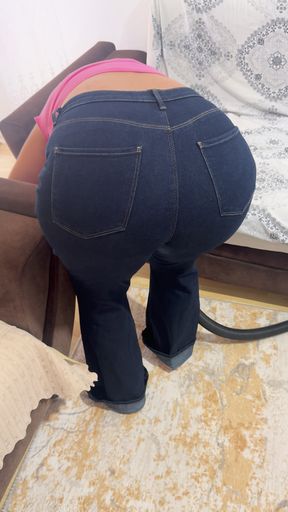 Curvy woman cleaning the house in trousers