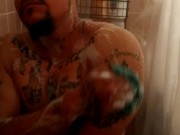 Sexy guy taking shower at the gym