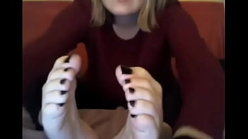 webcam model in sweatshirt suck her own toes