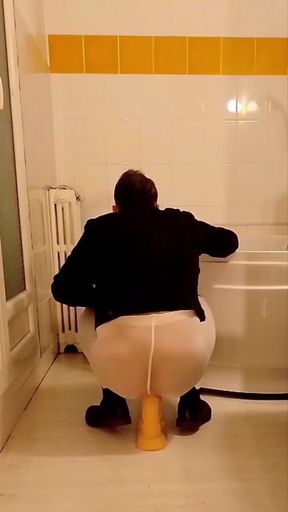 Dildo riding in the bathroom wearing an open white pantyhose