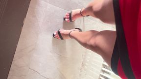 walking in black sandals and white toes