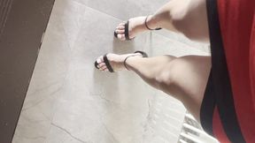 walking in black sandals and white toes