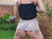 Girl pissing outside on the grass