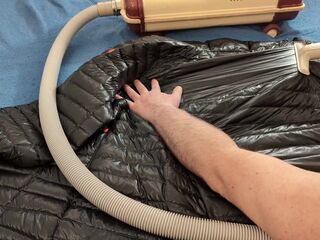 Vacuuming Darksome Shark Ghost Whisperer Down Jacket with Vintage Electrolux Vacuum Cleaner