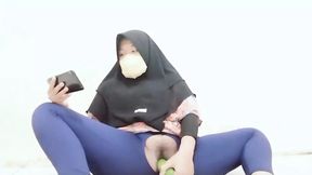 Indonesian hijab aunt wearing cucumber