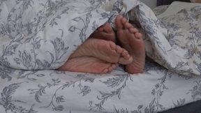 TWO PAIRS OF LEGS UNDER THE BLANKET