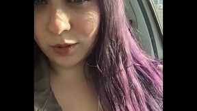 Naughty busty girl winks at the camera while she masturbates in public
