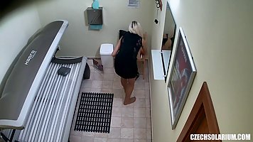 Sweet blonde is masturbating in the solarium, thinking that no one will see it happening