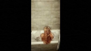 Blonde beauty masturbates in bubbly bath foam close up