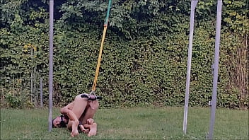 naked pathetic slave during outdoor party, handcuffed, testicles stretched in humbler, BDSM CBT