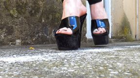 Toy scraper car crushed under sandal heels