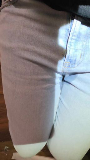 Desperately trying to hold but letting it all out in female light wash jeans