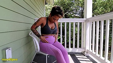 Loosey Lu wetting pink yoga pants on balcony