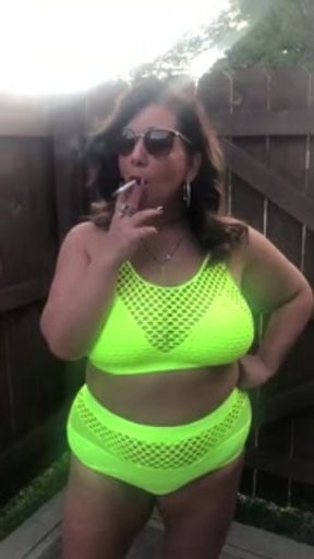 Curvy milf smoking outdoors