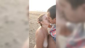 Hot couple's beach handjob and big natural tits
