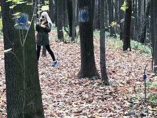 Golden-haired in the Forest Bangs Standing up with a Stranger on Camera