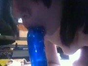 Sucking on "big blue" dildo