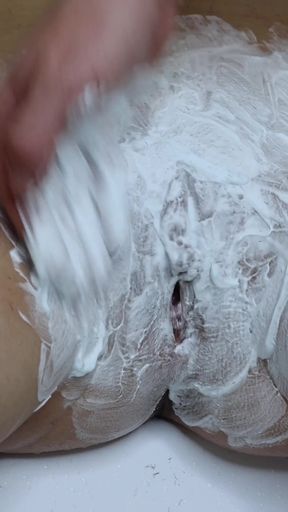 Shaving a hairy pussy with a large hole, close-up!   Clip 2
