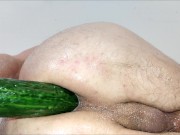 Close up cucumber insertion with massage oil and precum as lube