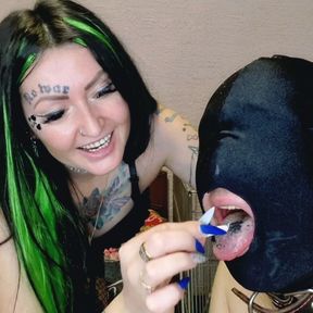 Smoking fetish. Dominatrix shakes cigarette ash on her slave&#039;s head and mouth.